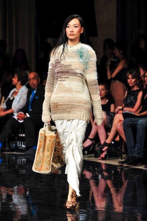 Runway look with pale hand-knit sweater and integrated textile accessory