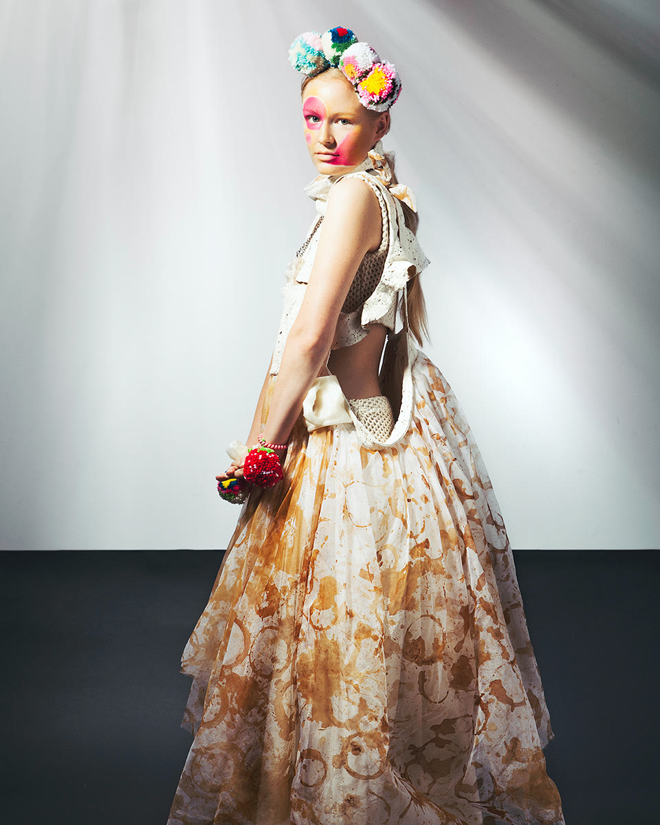 Editorial look in asymmetrical dress with raw-edge knit accents