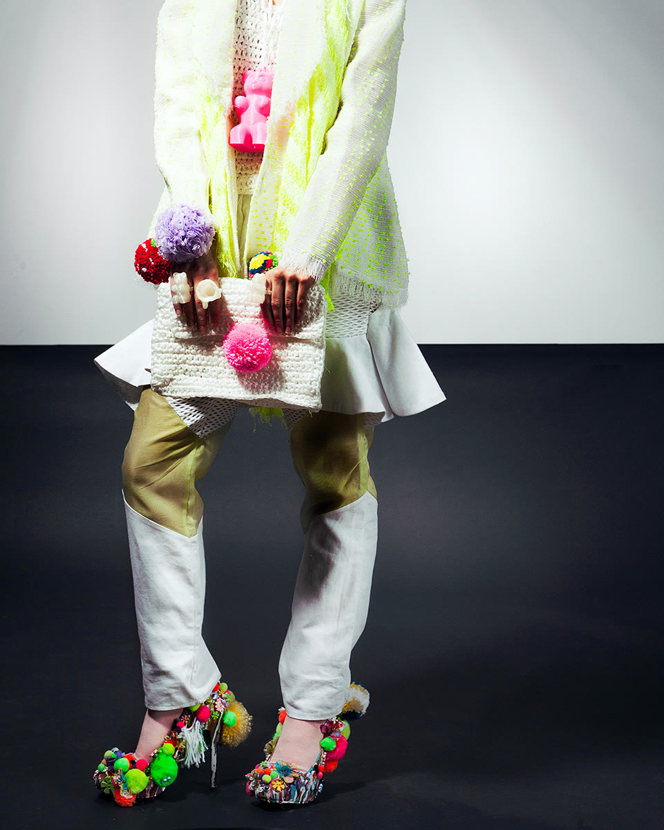 Editorial knitwear silhouette with sculptural accessories